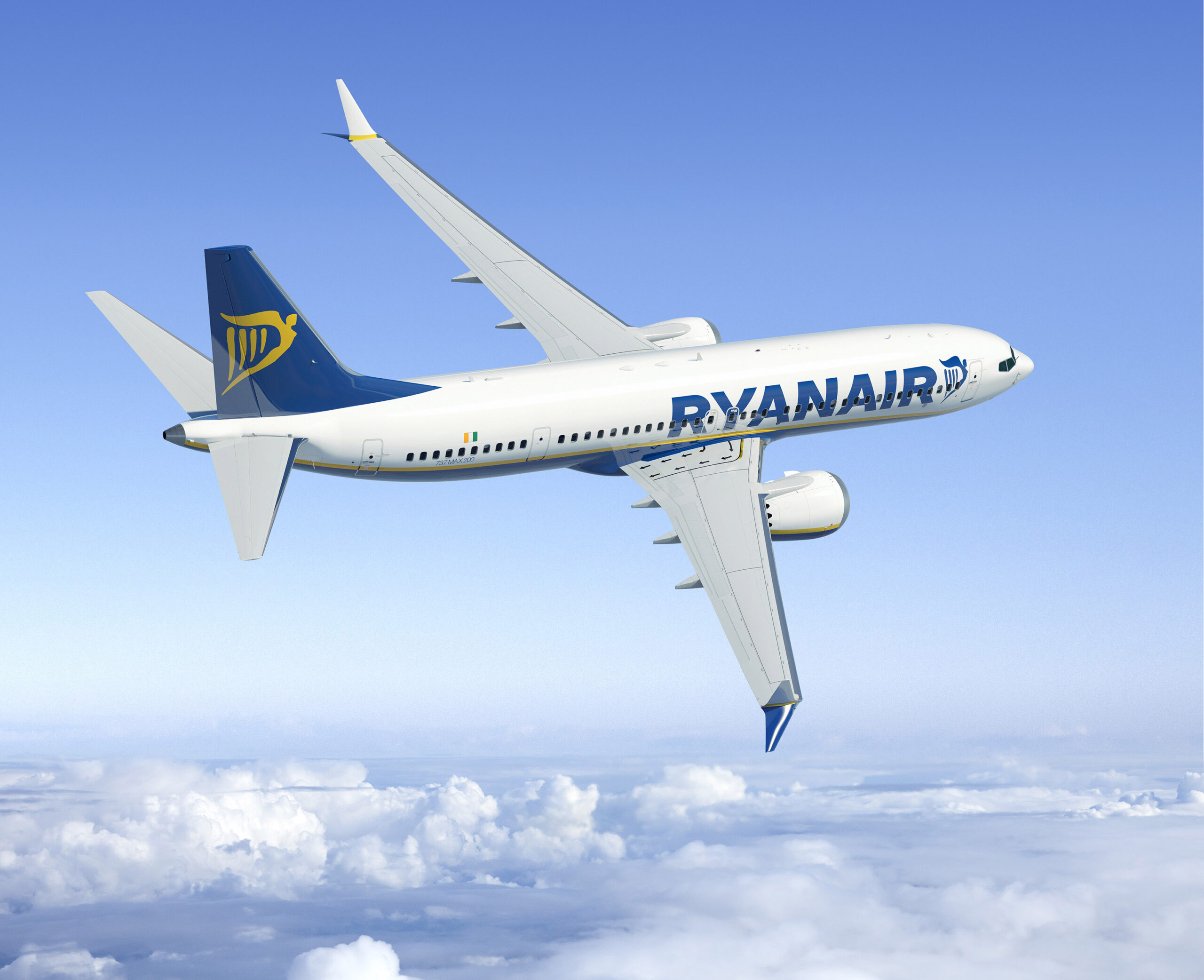 A white, blue, and yellow Ryanair jet flying over a layer of cloud.