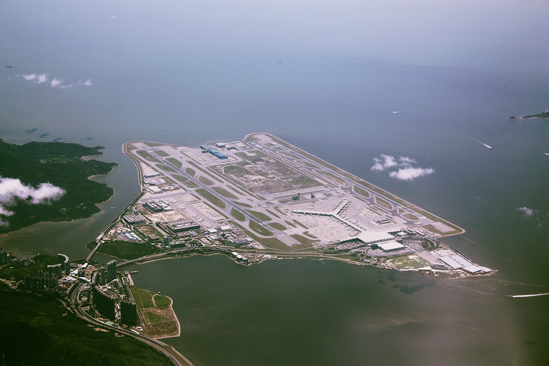 An aerial view of Hong Kong International Airport (HKG), the airport is surrounded by water.