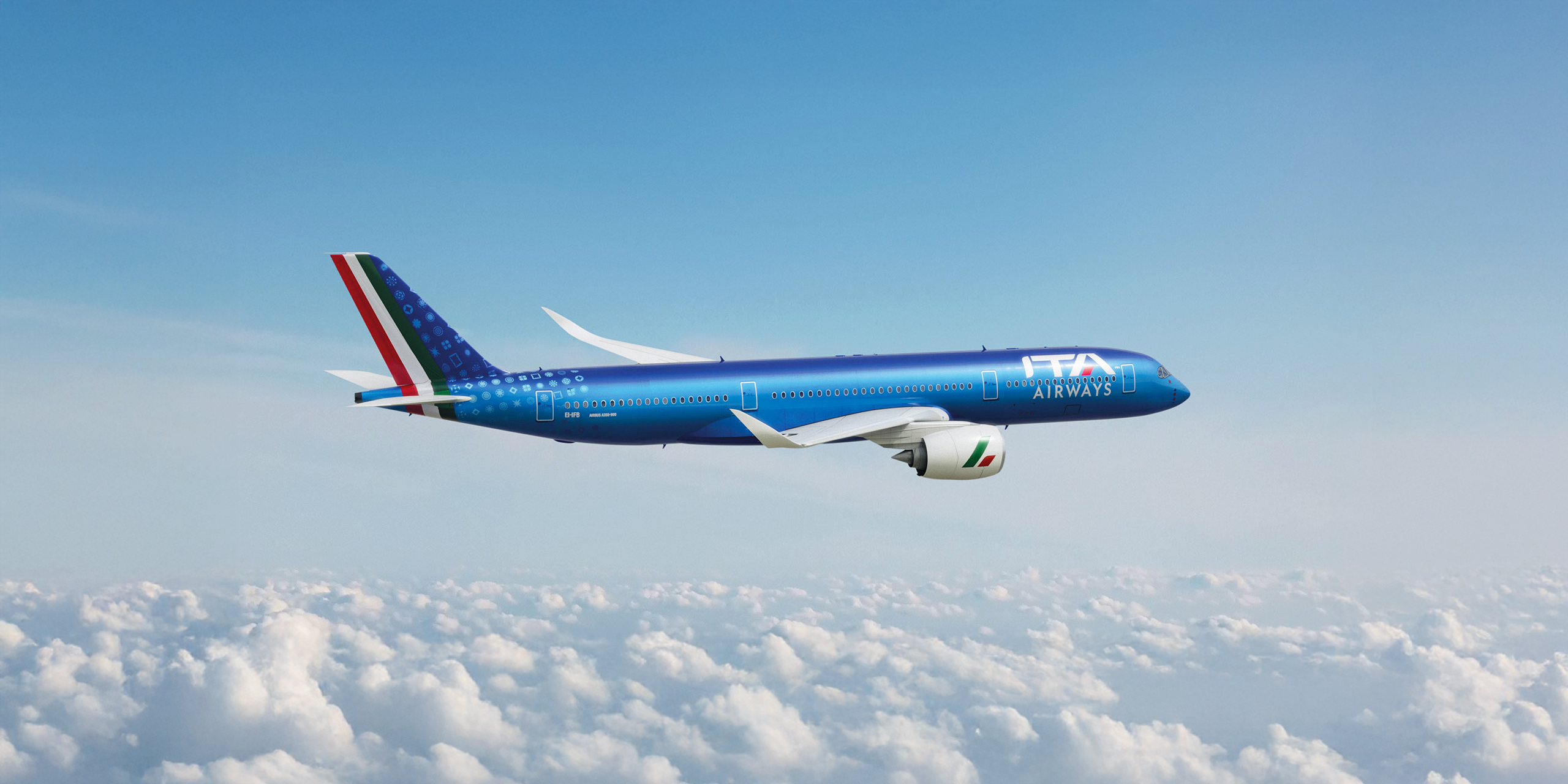 A blue ITA Airways jet flying above a layer of cloud against a blue sky.