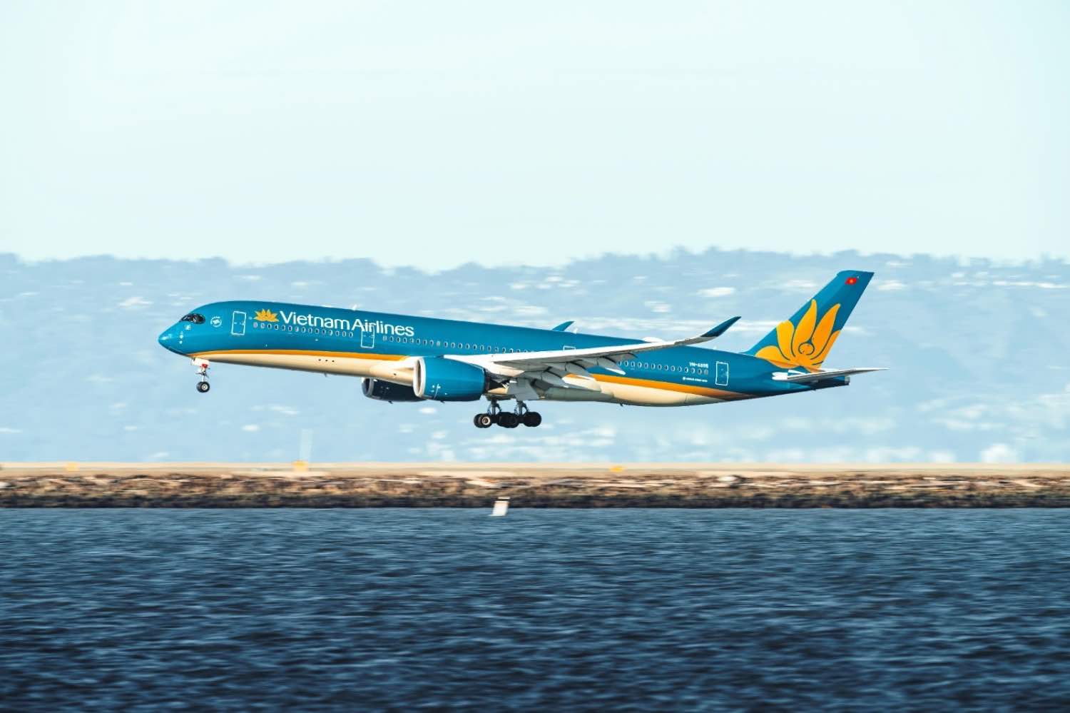 A Vietnam Airline Airbus A350 coming in to land over water