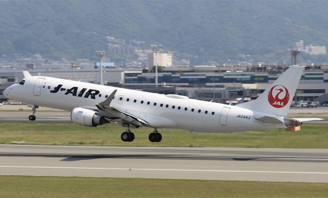 J-Air Embraer jet (JA244J) taking off, JAL crane logo on the tail.