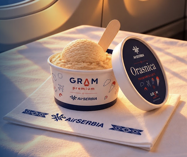 Image displaying a cup of a walnut cookie flavoured ice cream onboard, with the lid open on the right hand side 