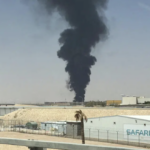 A large plume of black smoke rises from the fuel storage area at King Khalid International Airport in Riyadh, Saudi Arabia