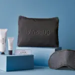 Singapore Airlines' new amenity kit for business class made in partnership with BYREDO, featuring a zip pouch with BYREDO's logo, three BYREDO products and an eye mask.