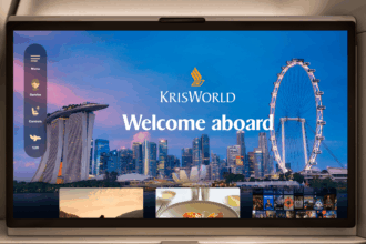 Seatback screen showing a welcome page over a dusk Singapore skyline with a large observation wheel, a side menu, and film and meal thumbnails below.