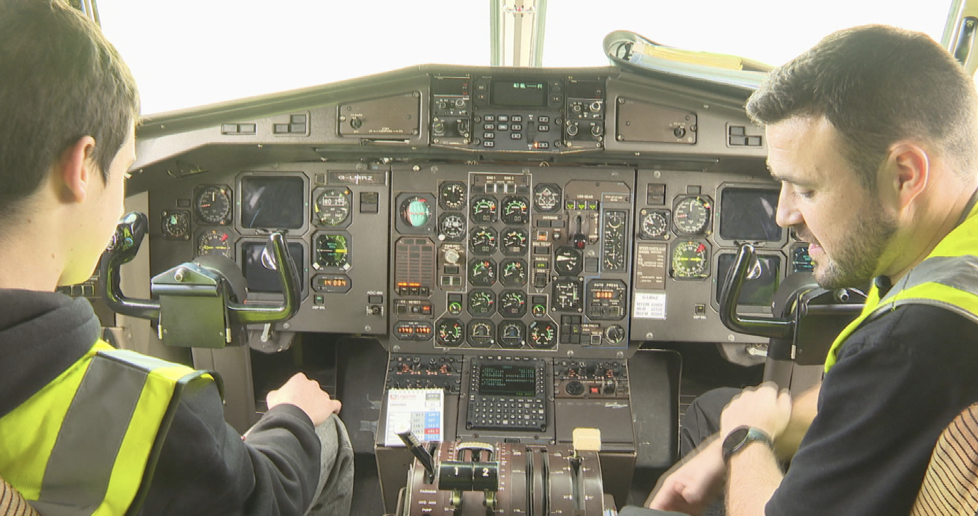 Dmytro Miskov and a member of Loganair's mechanic team in the cockpit of an aircraft