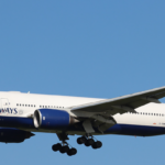 Image shows a British Airways Boeing 777 from the side. The livery is red, white and blue in the style of the UK flag.