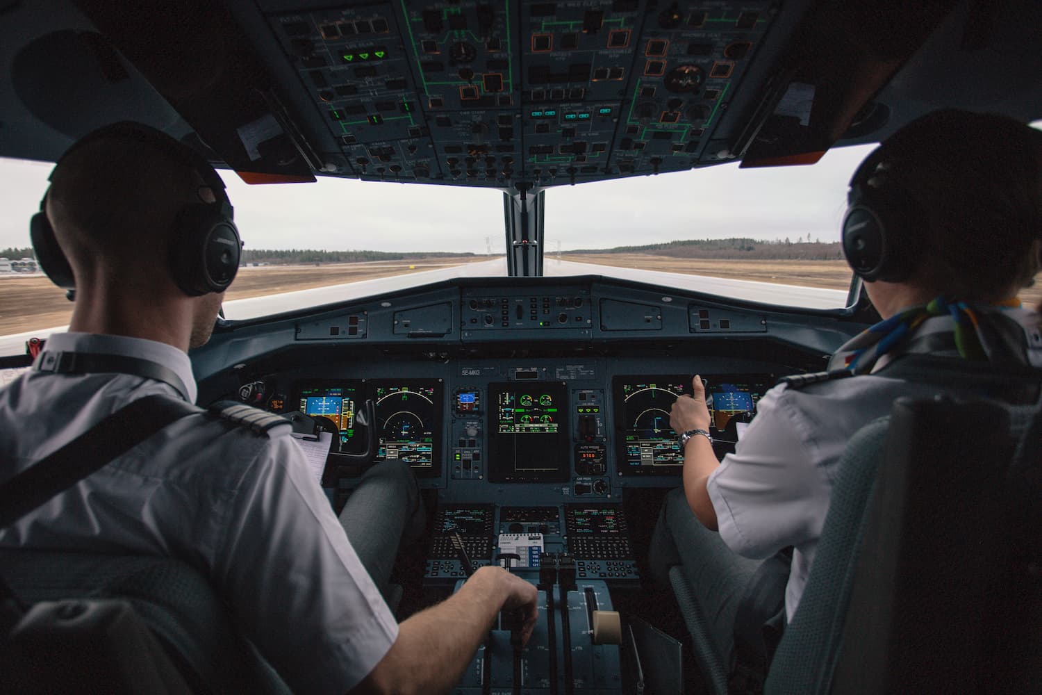 Image shows two pilots in a cockpit taking off