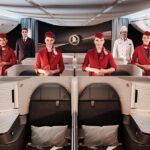 Turkish Airlines flight attendants standing in the new Crystal suite in the business class cabin.