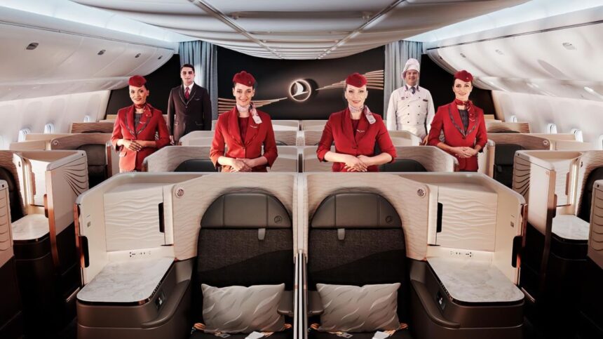 Turkish Airlines flight attendants standing in the new Crystal suite in the business class cabin.