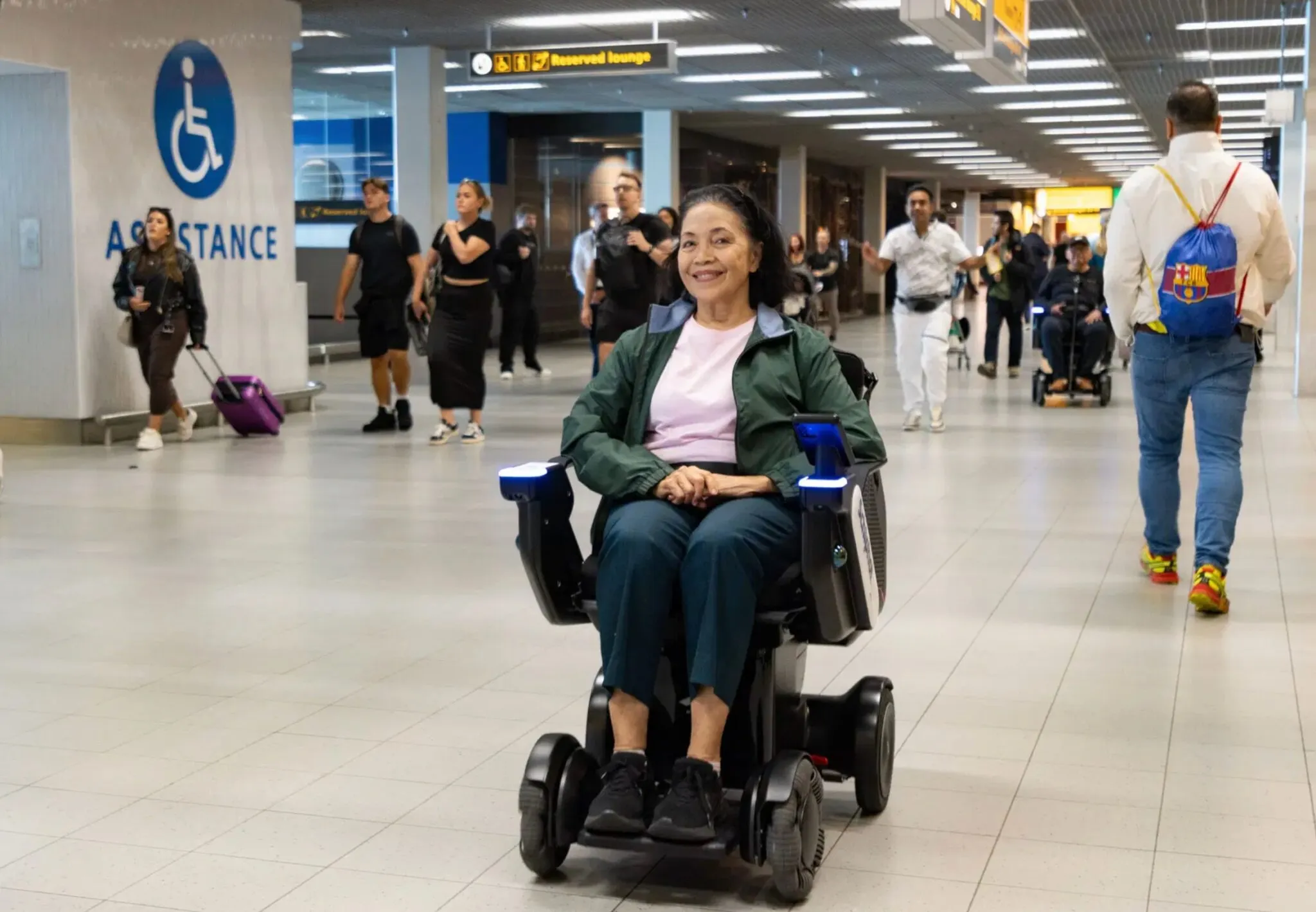 Woman in a wheelchair at an airport.