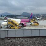 Wizz Air Airbus A321neo parked at Salzburg Airport with cloudy skies as a backdrop
