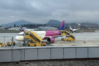 Wizz Air Airbus A321neo parked at Salzburg Airport with cloudy skies as a backdrop