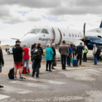 A group of people queueing into an REX flight in Albany Airport.