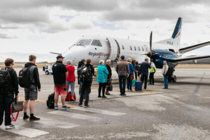 A group of people queueing into an REX flight in Albany Airport.