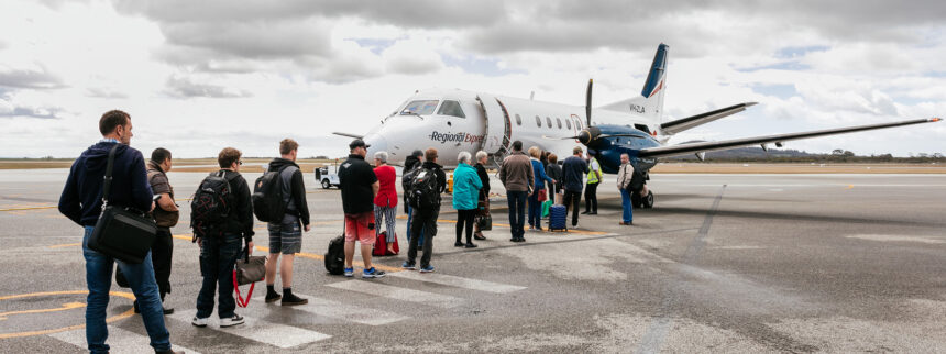 A group of people queueing into an REX flight in Albany Airport.