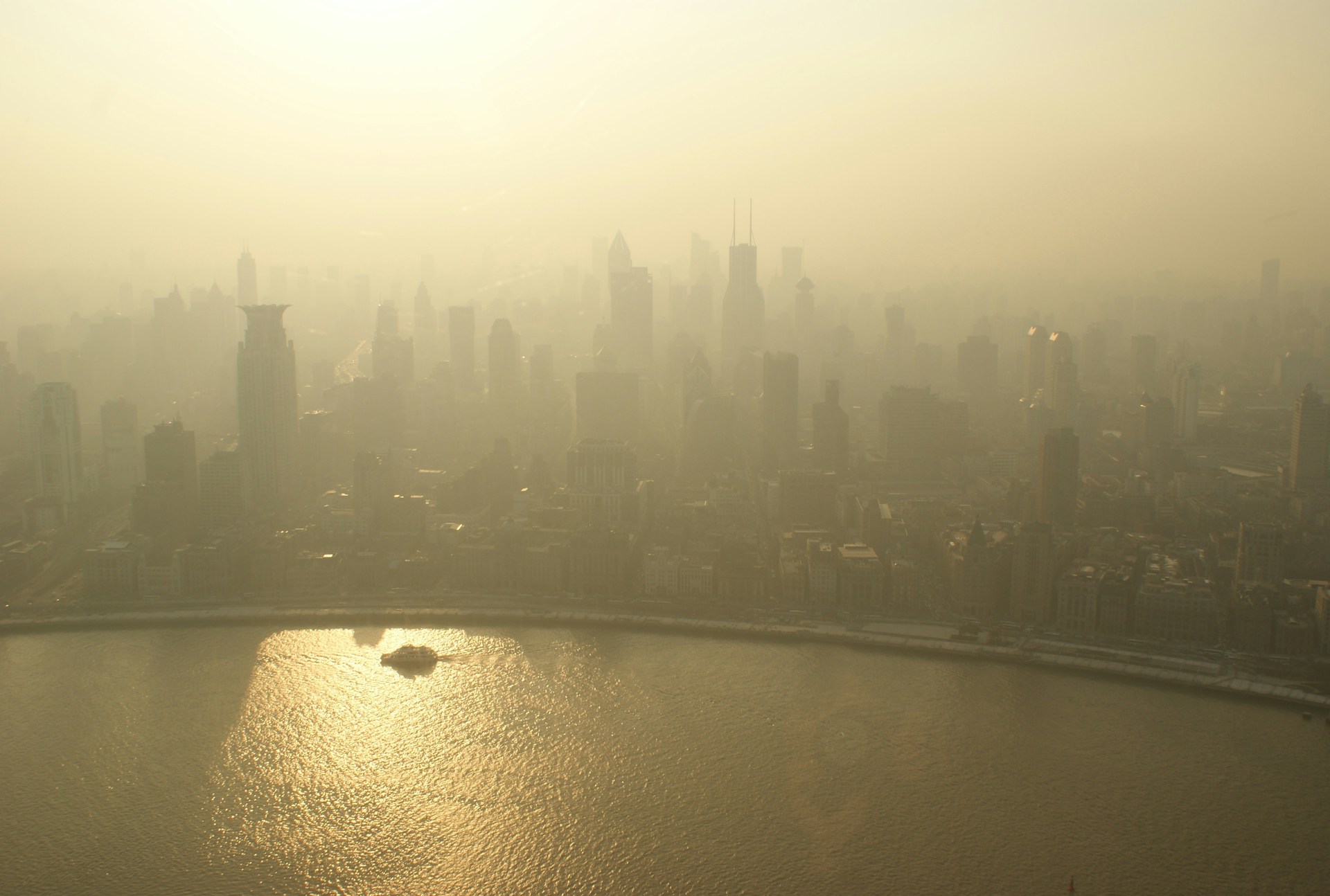 A city from above with haze causing yellowish skies