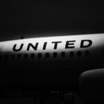 The side of a United Airline aircraft in the shadow