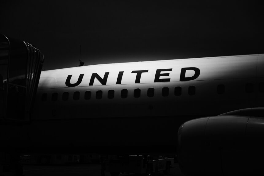 The side of a United Airline aircraft in the shadow