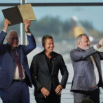U.S. Transportation Secretary Sean Duffy, center, reacts as he presents the certification for Boeing’s 737 Max 10 aircraft to Jim Williams, Boeing 737 Development Program chief engineer, left, and Chris Payne, Boeing Commercial Airplanes vice president and 737 Development Programs manager, right.