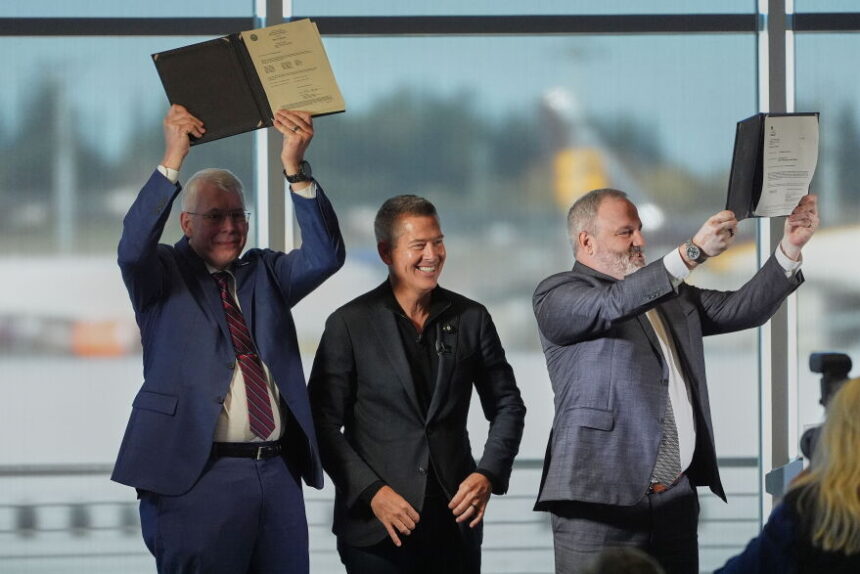 U.S. Transportation Secretary Sean Duffy, center, reacts as he presents the certification for Boeing’s 737 Max 10 aircraft to Jim Williams, Boeing 737 Development Program chief engineer, left, and Chris Payne, Boeing Commercial Airplanes vice president and 737 Development Programs manager, right.