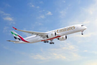 Photograph depicting the Emirates Airbus A350 flying above the clouds during daytime.