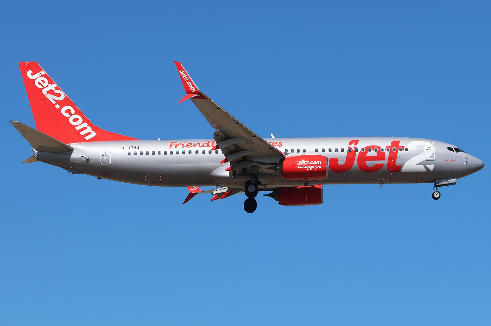 A Jet2 Boeing 737-8MG(WL) mid-air with its landing gear extended.