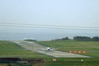 Image shows a Ryanair flight touching down at Leeds Bradford Airport