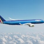 Image shows a blue branded ITA Airways aircraft in a blue sky with white clouds below