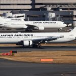 A Japan Airlines Boeing 767-346ER on the ground with two other Japan Airlines aircraft behind it.