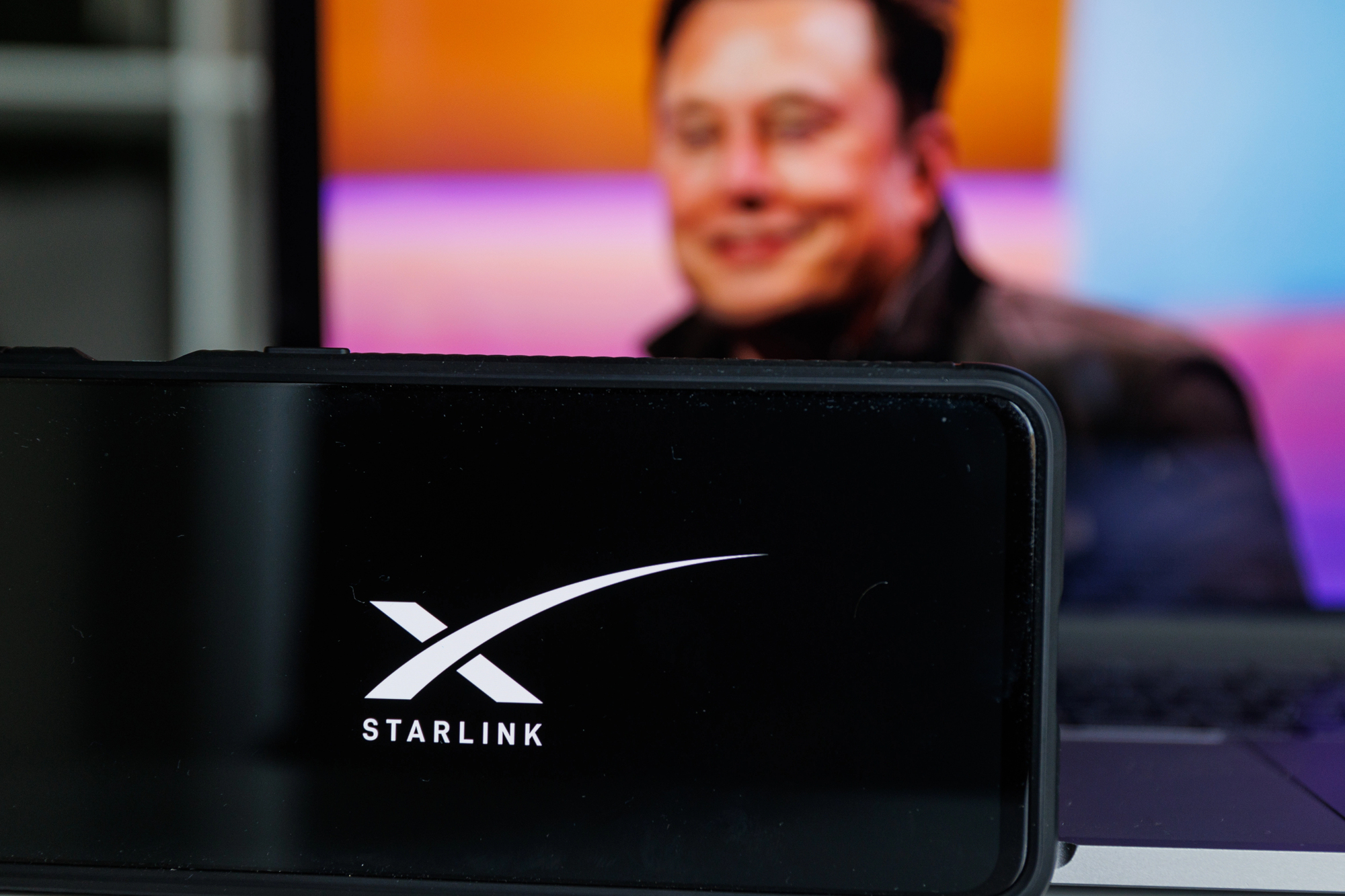 Kaunas, Lithuania. 2022: Starlink logo on screen and Elon Musk in background. © Rokas91 https://depositphotos.com/home.html