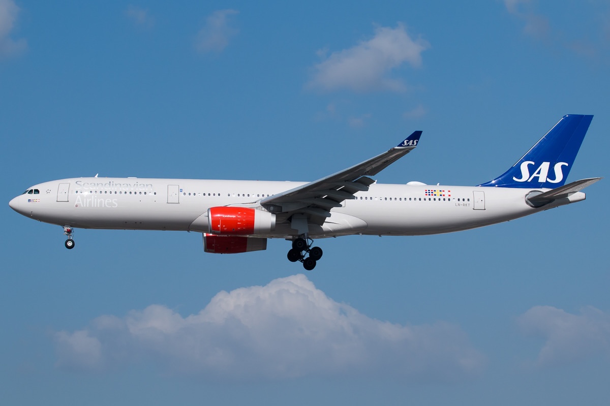 A SAS Airbus A330-343 mid air with its landing gear extended.