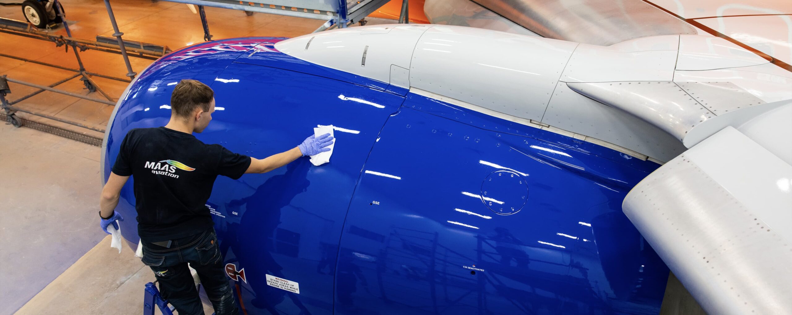 MAAS Aviation employee wiping an aircraft