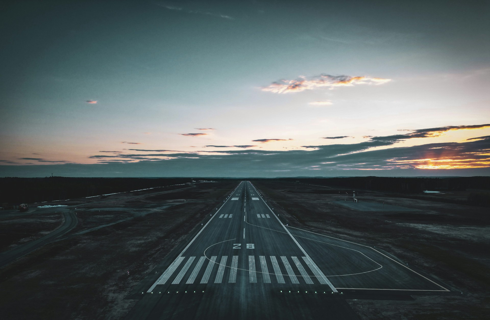 An airport runway from above at sunset