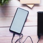 Power bank and phone on a wooden desk