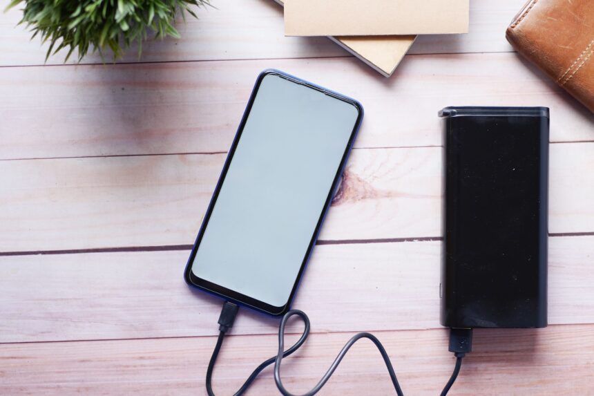Power bank and phone on a wooden desk