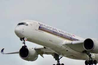 Close-up of Singapore Airlines Airbus A350 aircraft during flight, showcasing its design and engineering.