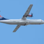Air Serbia plane travelling East in the background of a bright blue sky