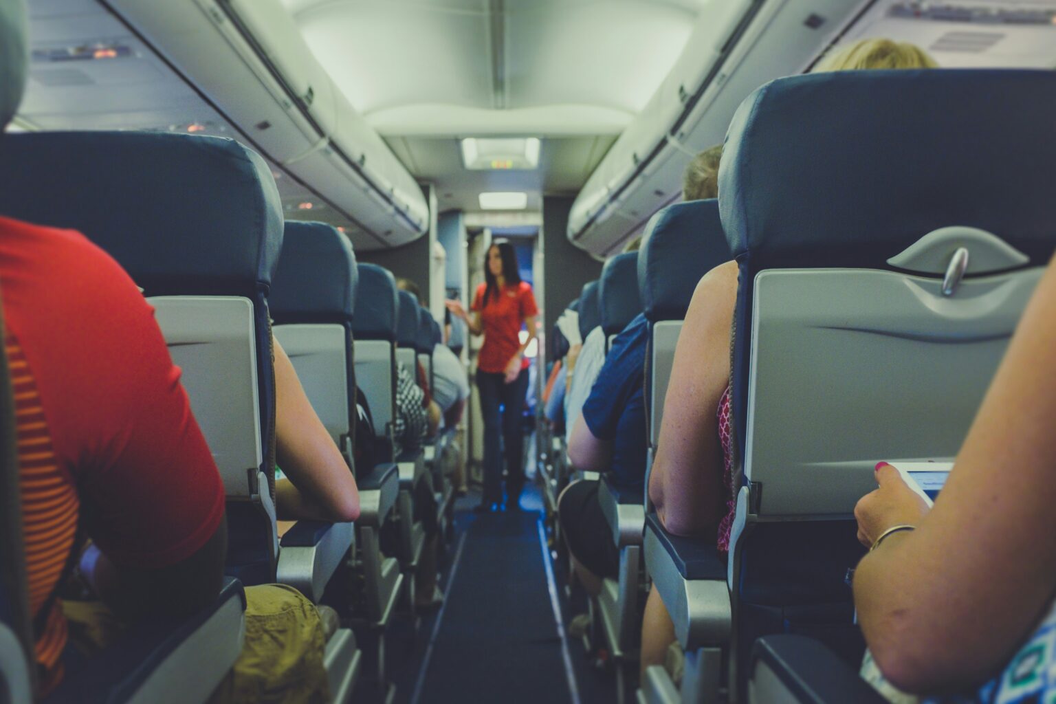 Image of cabin isle where passengers are sat in their seats, listening to the cabin crew. 2017 © Quilia