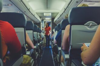 Image of cabin isle where passengers are sat in their seats, listening to the cabin crew. 2017 © Quilia