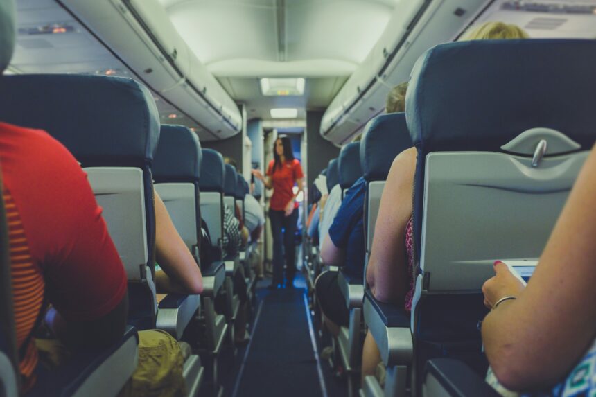 Image of cabin isle where passengers are sat in their seats, listening to the cabin crew. 2017 © Quilia