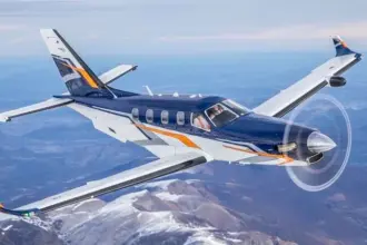 Photo of a Daher aircraft in the sky above the sea facing eastwards