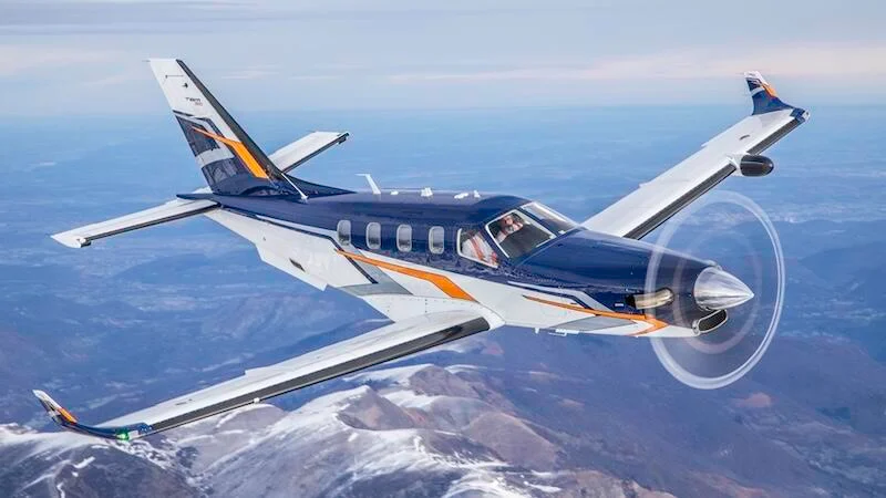 Photo of a Daher aircraft in the sky above the sea facing eastwards